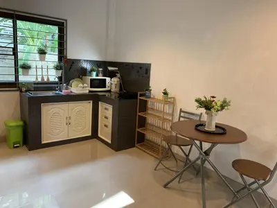 a kitchen with a table and a small table with chairs at Kata House in Kata Beach