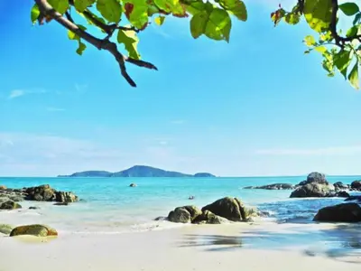 a beach with rocks and the ocean in the background at Rawai Beach Pool Villa 3 bedrooms in Rawai Beach