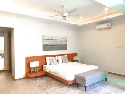 a bedroom with a bed and a ceiling fan at Rawai Beach Pool Villa 3 bedrooms in Rawai Beach