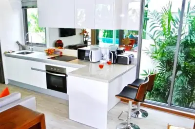 a kitchen with white cabinets and a counter top at Rawai Beach Pool Villa 3 bedrooms in Rawai Beach