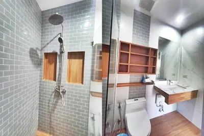 a bathroom with a shower and a toilet and a sink at Ohophuket in Phuket Town