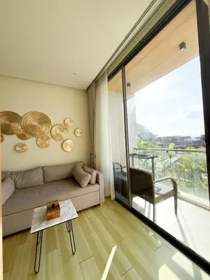 a living room with a couch and a large window at The Rocco pool view in Krabi town