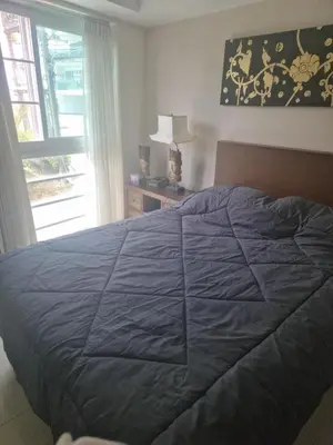 a bedroom with a large bed and a window at Condo for rent Kata Beach in Kata Beach