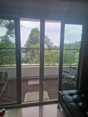 a room with a window with a view of a balcony at Condo for rent Kata Beach in Kata Beach