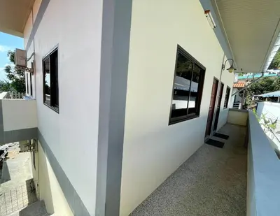 a hallway of a house with two windows at Kata House 2 in Kata Beach