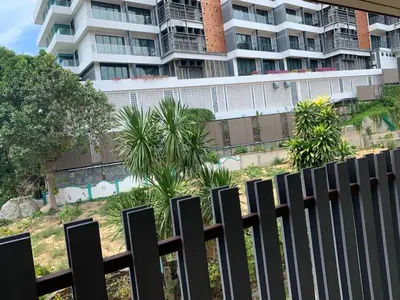 a fence in front of a large building at Kata House 2 in Kata Beach