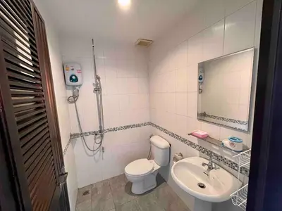 a bathroom with a toilet and a sink at Kata House 2 in Kata Beach