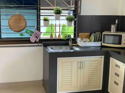 a kitchen with a sink and a microwave at Kata House 2 in Kata Beach
