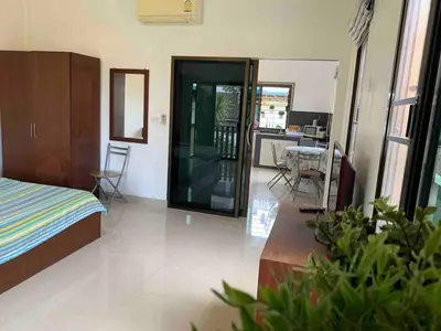 a bedroom with a bed and a table and chairs at Kata House 2 in Kata Beach