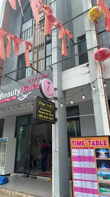 a branch of a bank with pink signs on a building at Cat Home Ao Nang Landmark in Ao Nang Beach