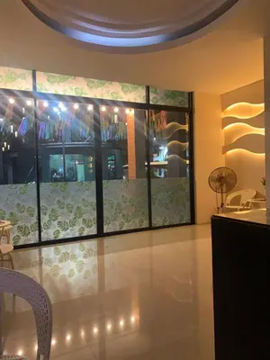 a dining room with a large window with lights at Cat Home Ao Nang Landmark in Ao Nang Beach