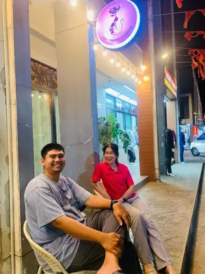 two people sitting in chairs in front of a store at Cat Home Ao Nang Landmark in Ao Nang Beach