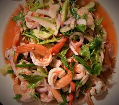 a salad with shrimp and vegetables in a bowl at Villa Tha Maphrao in Ban Pa Khlok