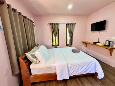 a small bedroom with a bed and a tv at Abir Homestay Koh Yao Yai in Ban Phlu Nai