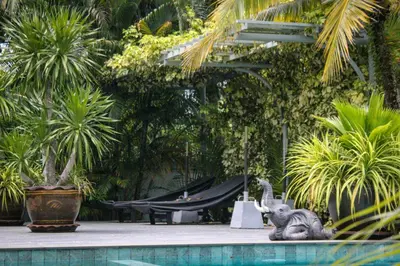 an elephant statue next to a pool in a garden at sengjan garden krabi in Ban Khlong Son