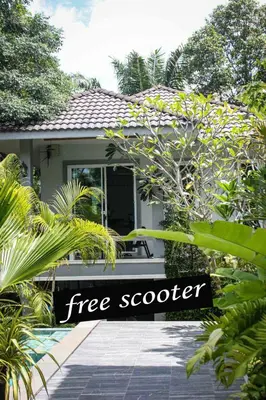 a house with a free scotter sign in front of it at sengjan garden krabi in Ban Khlong Son