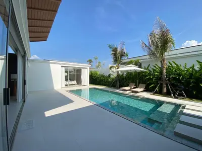 a swimming pool in the backyard of a house at 3bdr New Modern Pool Villa Bangtao ASH-05 in Ban Phru Champa