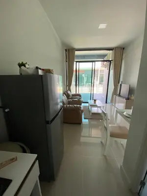 a kitchen with a refrigerator and a living room at 9169SiriplaceAirport in Ban Muang Mai (1)