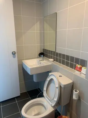 a bathroom with a sink and a toilet and a mirror at 9169SiriplaceAirport in Ban Muang Mai (1)