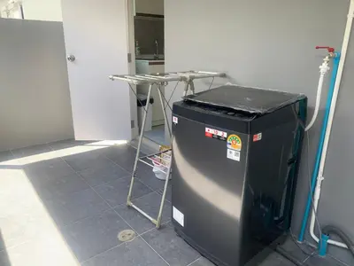 a room with a trash can and a table at 9169SiriplaceAirport in Ban Muang Mai (1)