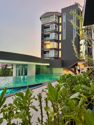 a swimming pool in front of a building at Luxury 2 Person Apartment in Heart of Phuket in Ban Ket Ho