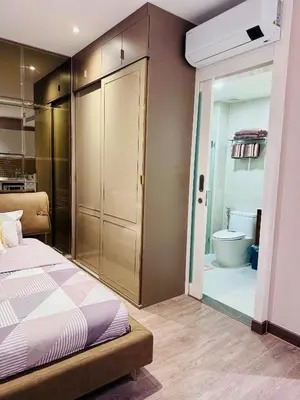 a bedroom with a bed and a bathroom with a toilet at Luxury 2 Person Apartment in Heart of Phuket in Ban Ket Ho