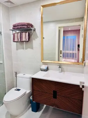 a bathroom with a toilet and a sink and a mirror at Luxury 2 Person Apartment in Heart of Phuket in Ban Ket Ho