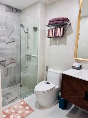 a bathroom with a shower and a toilet and a sink at Luxury 2 Person Apartment in Heart of Phuket in Ban Ket Ho