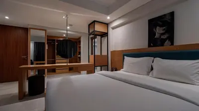 a bedroom with a large bed and a desk at Luxury Modern Loft Villa Riverhouse in Laguna Phuket