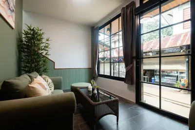 a living room with a couch and a window at Kewalin hostel in Phi Phi Don