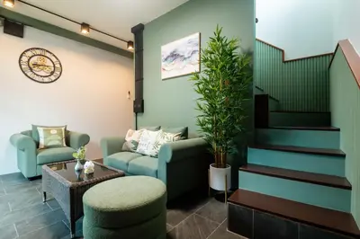 a living room with a couch and a chair and a table at Kewalin hostel in Phi Phi Don