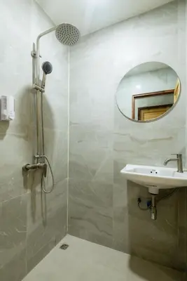 a bathroom with a sink and a mirror at Kewalin hostel in Phi Phi Don