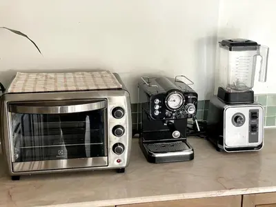 a kitchen counter with a microwave and a blender at 3-bed house with Private beach in Ban Ao Makham