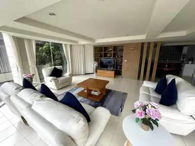 a living room with white furniture and blue pillows at 3-bed house with Private beach in Ban Ao Makham