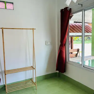 a room with a ladder next to a window at Lamsai AC Sea House Green in Ko Yao Noi