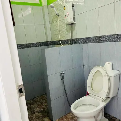 a bathroom with a toilet and a shower in it at Lamsai AC Sea House Green in Ko Yao Noi