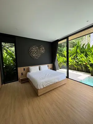 a bedroom with a bed and a large window at Villa Aileen Naithon in Nai Thon Beach