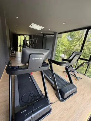 a gym with two treadmill and two tread machines at Villa Aileen Naithon in Nai Thon Beach
