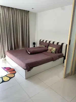 a bedroom with a large bed in a room at Sea View & Pool Apartment in Phuket Town