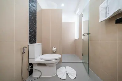 a small bathroom with a toilet and a shower at The Greens Phuket Villa with swimming pool 18 in Ban Saiyuan (1)
