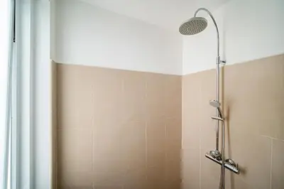 a shower with a shower head in a bathroom at The Greens Phuket Villa with swimming pool 18 in Ban Saiyuan (1)