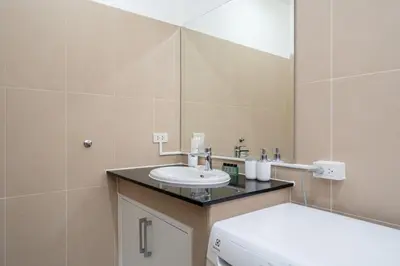 a bathroom with a sink and a toilet and a mirror at The Greens Phuket Villa with swimming pool 18 in Ban Saiyuan (1)