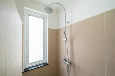 a shower in a bathroom with a window at Brand New 3 Bedroom Pool Villa 18 in Ban Saiyuan (1)