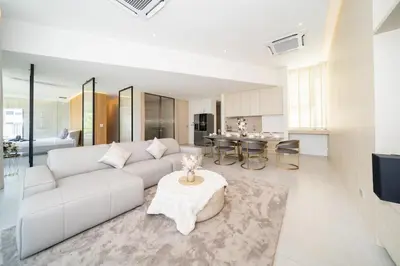 a living room with a white couch and a table at Penthouse Luxurious Seaview Patong in Patong Beach