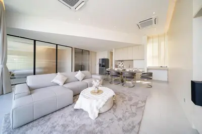 a living room with a white couch and a table at Penthouse Luxurious Seaview Patong in Patong Beach