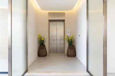 a mirror in a hallway with two vases with flowers at Penthouse Luxurious Seaview Patong in Patong Beach