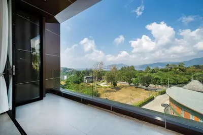 a room with a large window with a view at Penthouse Luxurious Seaview Patong in Patong Beach