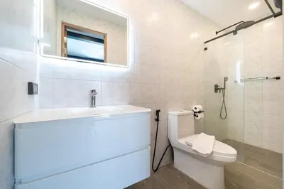 a bathroom with a toilet and a sink and a mirror at Innovative 4BR Villa Sunset Garden 1 with Oxygen Pool in Rawai Beach