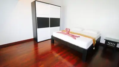 a room with a bed with a pink ribbon on it at Villa Patong 3 Chambres in Patong Beach