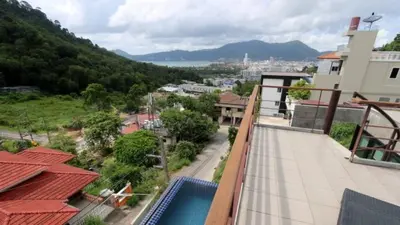 a balcony of a house with a view of a city at Villa Patong 3 Chambres in Patong Beach